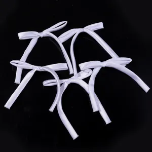 Handmade white ribbon bows detail view, ideal for DIY hair clips and gift packaging decor.