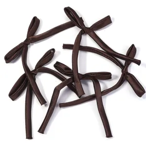 Detail shot of brown satin ribbon bows, ballet style DIY clothing accessories and gift decorations.