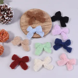 Detailed view of handmade knitted yarn bow accessories in colorful options for DIY clothing crafts.