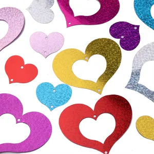 Colorful holographic heart sequins and hollow pendants for wedding and party decorations detail.