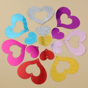 Close-up detail of colorful hollow heart sequins, sparkling decorative pendants for party.