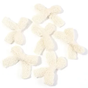 Detailed view of handmade knitted wool bows, off-white double layer DIY clothing accessories.