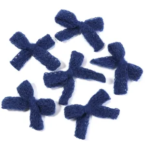 Dark blue knitted bow detail shot, perfect for DIY clothing, hair accessories and craft projects.