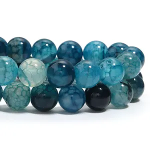 Close-up detail shot of blue crackle agate round beads, showing natural cracked stone texture.