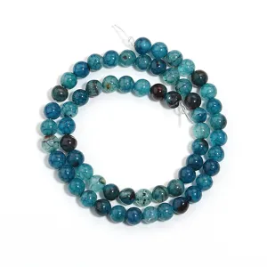 Close-up detail of blue crackle dragon vein agate round loose beads for DIY jewelry making.