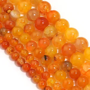 Close-up detail of natural orange dragon vein agate round beads for DIY jewelry making.