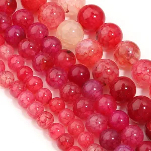 Close-up detail of red cracked agate loose beads, ideal for DIY jewelry making and crafting projects.