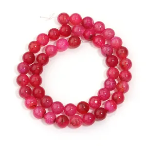 Detailed view of pink crackled agate round beads, perfect for DIY jewelry making accessories.