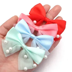 Multi-color ribbon bows with mesh and pearl embellishments, perfect for hair accessories or DIY crafts.