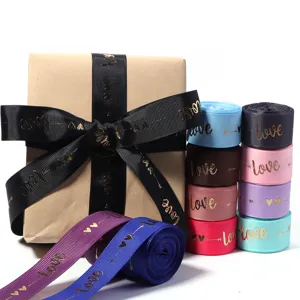Detailed view of colorful polyester foil printed ribbons and gift packaging bow for DIY crafts.