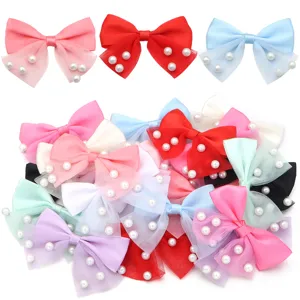 Detailed view of colorful mesh bow hair clips with pearl decorations, assorted colors.