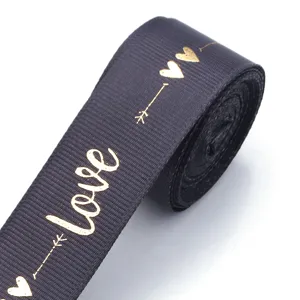 Black polyester ribbon with gold foil love print, ideal for DIY gift wrapping and crafts.