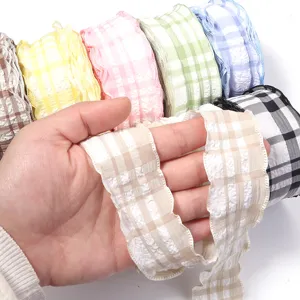 Detail view of polyester plaid crinkle ribbon showing delicate texture and ruffled edge.