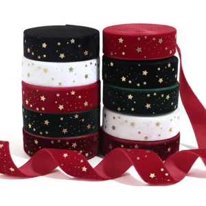 Close-up detail of multi-color velvet ribbon rolls with golden foil stars for DIY crafts.
