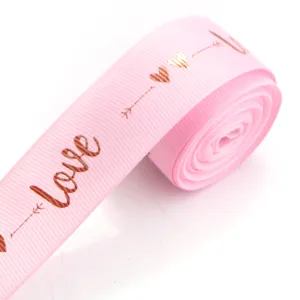Pink polyester grosgrain ribbon with gold foil love print for gift packaging and DIY bows.