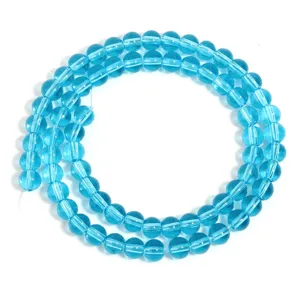 Close-up of lake blue transparent glass beads, perfect for DIY jewelry making and craft projects.