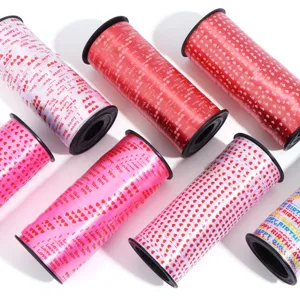 Detailed view of colorful decorative ribbon rolls featuring heart prints for gift wrapping.