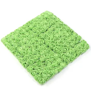Detailed shot of light green artificial PE foam rose flower heads with mesh packaging.