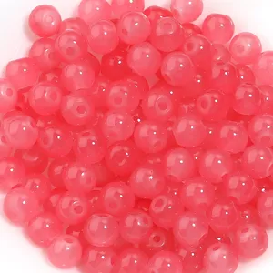 Gros plan de perles rondes en verre rose pour la conception de bijoux artisanaux DIY bracelet.