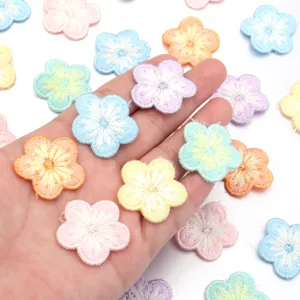 Colorful embroidered flower patches with metallic gold edge for DIY clothing repairs and crafts.