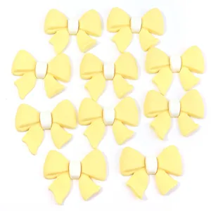 Gele strik PVC zacht rubberen patches voor DIY haarspelden telefoonhoesjes accessoires.