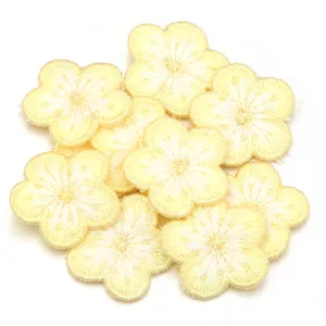 Detailed view of yellow plum blossom embroidery patch, flower applique for DIY crafts and clothing.