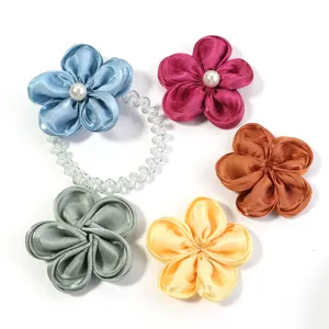 Detailed shot of five-petal fabric satin flower hair accessories DIY craft materials.