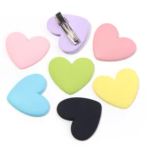Close-up details of colorful resin heart hair clips and DIY phone case accessories.