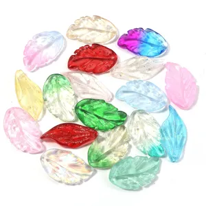 Close-up detail of colorful leaf beads, transparent glaze pendant charms for DIY jewelry making.