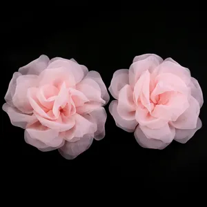 Detailed view of pink double layer mesh rose fabric flowers for DIY crafts and accessories.