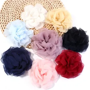Detail shot of multi-color chiffon mesh rose fabric flowers for DIY crafts and accessories.