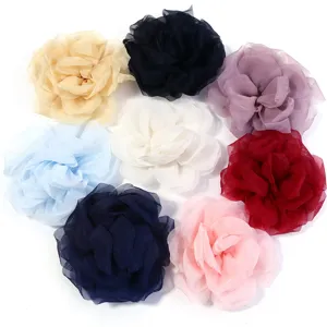 Detailed view of multi-color chiffon mesh rose flowers for DIY hair and clothing accessories.