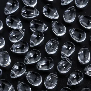 Clear glass teardrop beads detail shot, perfect for DIY jewelry making and hair accessories.
