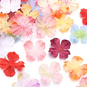 Details of colorful four-petal artificial fabric flower patches for DIY handmade crafts.