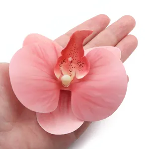 Closeup of artificial fabric orchid flower head showing realistic petal texture and color.