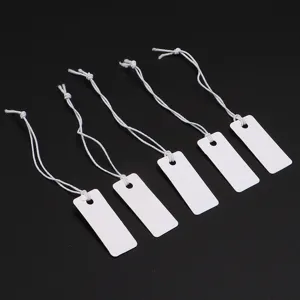 Blank white hang tags with elastic strings for jewelry, clothing, and retail display price cards.