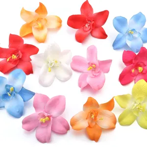 Colorful artificial fabric orchid flower heads detail view for DIY hair accessories crafts.