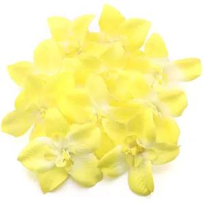 Yellow artificial orchid flower heads for wedding decoration, floral wall and DIY accessories.