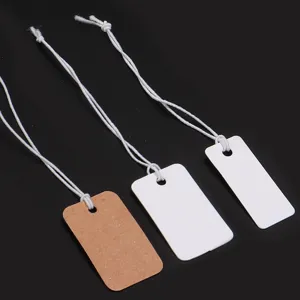 Detailed close-up view showing blank paper hang tags with elastic strings for price display.