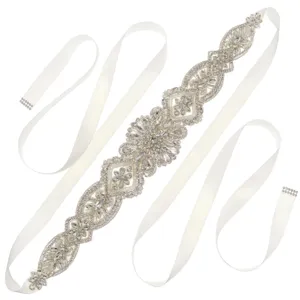 Bridal rhinestone belt with sparkling crystals and white satin ribbon for wedding dress.