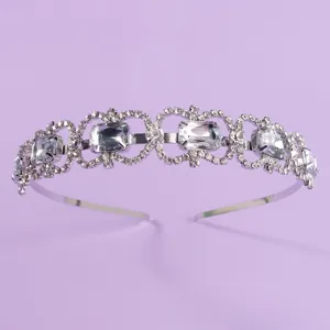 Elegant crystal rhinestone bridal headband for wedding party, shiny silver hair accessory.