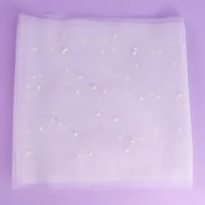 Pearl decorated tulle veil for wedding, bridal photo shoot, and party hair accessory.