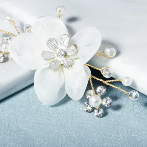 Hand-woven white flower shoe clip with pearls and rhinestones, perfect for bridal wedding shoes.