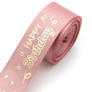 Pink gold foil happy birthday polyester ribbon detail shot, perfect for gift wrapping and parties.
