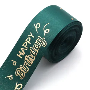 Dark green polyester ribbon featuring gold hot-stamped happy birthday text, detail shot.