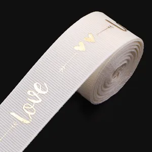 White polyester ribbon with gold foil love and heart print, perfect for gift wrapping and DIY bows.