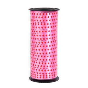 Pink heart print ribbon spool for gift box wrapping and holiday party decoration.