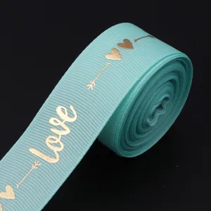 Turquoise polyester ribbon featuring gold hot-stamped love and heart patterns, perfect for DIY gifts.