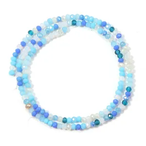 Close-up detail of mixed blue faceted crystal glass spacer beads for DIY jewelry making.