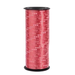 Red gift wrapping ribbon detail with heart prints and love text, perfect for festive party decor.
